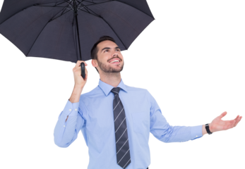 Happy businessman sheltering with a black umbrella