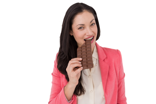 Smiling brunette biting bar of chocolate