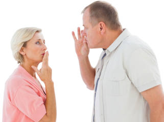 Older couple holding hands to mouth for silence