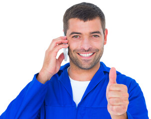 Mechanic using mobile phone while gesturing thumbs up