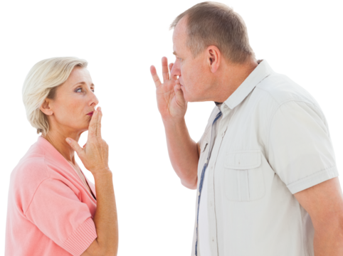 Older couple holding hands to mouth for silence