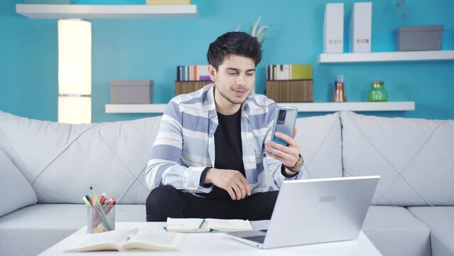 The chatty young man who likes to talk speaks without breathing.
The young man who is chatting facetime with his friend talks a lot and his chatter never stops.
