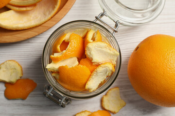 Naklejka na ściany i meble Orange peels preparing for drying and fresh fruit on white wooden table, flat lay