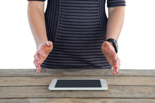 Mid section of businesswoman gesturing over digital tablet