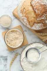 Flat lay composition with sourdough on white marble table