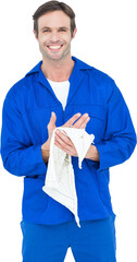 Confident mechanic wiping hand with napkin