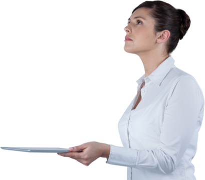 Businesswoman looking up while holding digital tablet