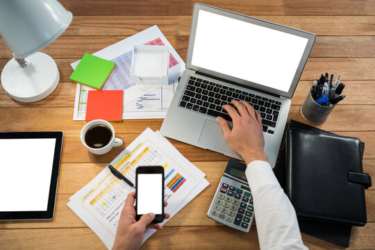 Cropped image of hand working at desk