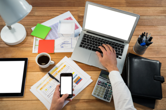 Cropped image of hand working at desk