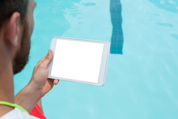Lifeguard using digital tablet at poolside