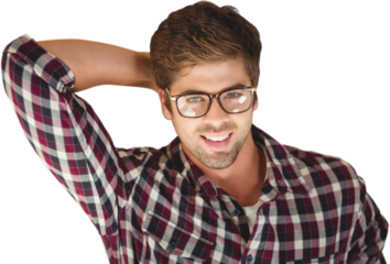 Hipster smiling while lying by laptop on hardwood floor