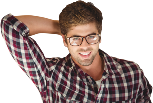 Hipster smiling while lying by laptop on hardwood floor