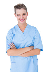  Smiling nurse in blue scrubs posing with arms crossed