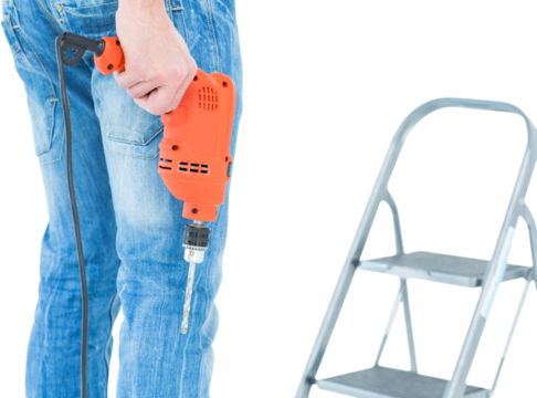 Worker holding drill in front of step ladder