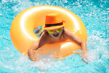 Kids swim with float ring on summer vacation holidays.