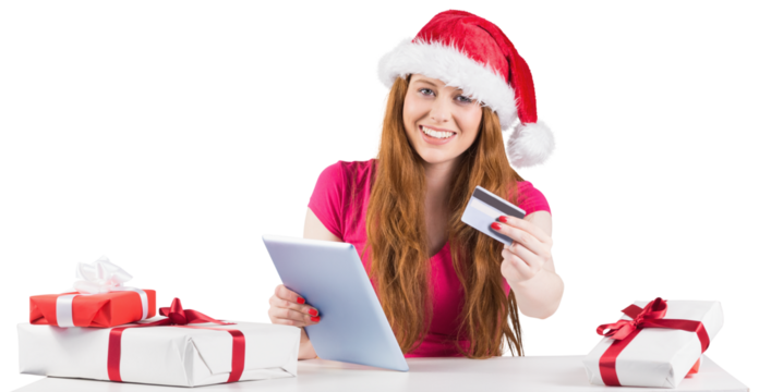 Festive redhead shopping online with tablet