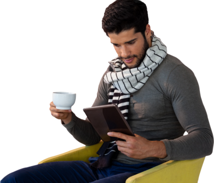 Man using digital tablet while having tea on seat