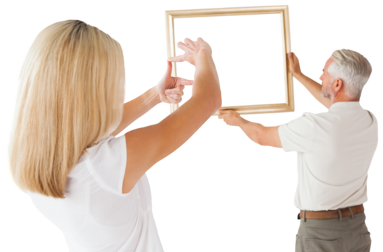 Couple hanging a frame together