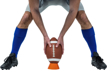 American football player placing ball between legs