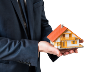 Businessman holding miniature house model
