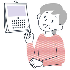 カレンダーを見て日にちを確認するシニア女性の上半身