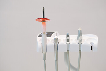 Dental led polymerization inlay onlay devices at dentist office clinic. Selective focus of devices. Open space area.