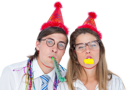 Geeky hipster wearing a party hat with blowing party horn