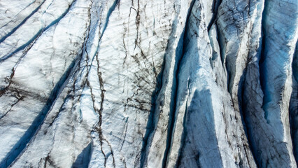 Huge glacier with pure blue ice at sunny weather. Vatnajokull glacier in Iceland. Beautiful nature abstract background. Ice texture landscape aerial view.