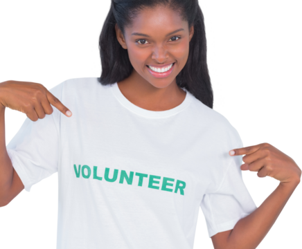 Smiling young woman wearing volunteer tshirt and pointing to it