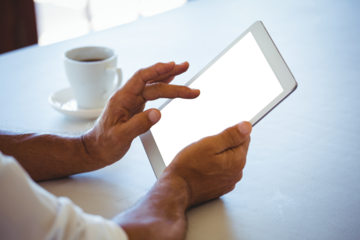 Man using digital tablet at cafe