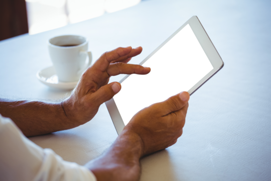 Man using digital tablet at cafe