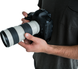 Mid section of male photographer holding digital camera