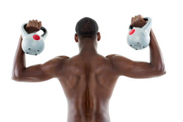 Rear view of shirtless fit man lifting kettle bells