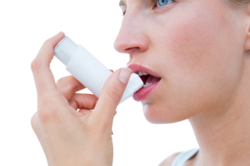 Blonde woman taking her inhaler