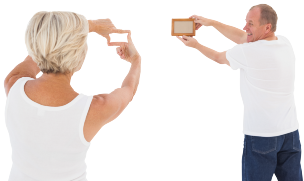 Mature couple hanging up picture frame
