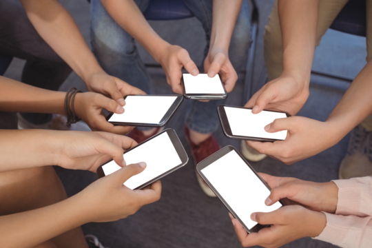 Students holding mobile phones - Powered by Adobe