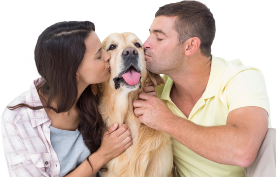 Couple with eyes closed kissing dog