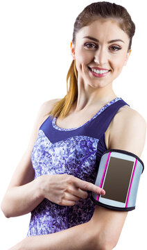 Portrait of fit woman showing smartphone in armband