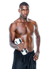 Portrait of a fit shirtless young man lifting dumbbell