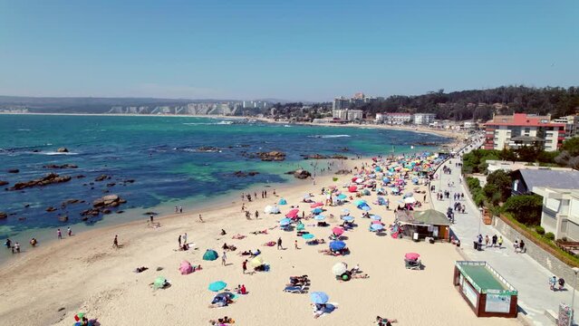 People Sunbathing On The Sea And Spending Last Days Of Summer At Pejerrey Beach In Algarrobo, Chile. aerial