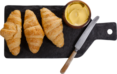 Croissant with cheese on chopping board