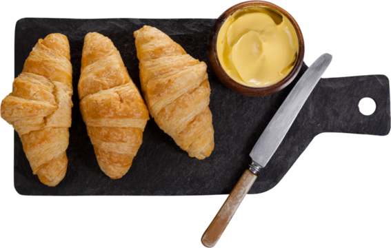 Croissant with cheese on chopping board - Powered by Adobe
