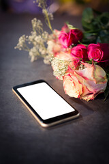 Mobile phone by fresh flowers