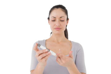 Diabetic brunette using blood glucose monitor