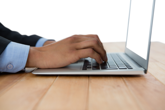 Cropped hands of businessman typing on laptop