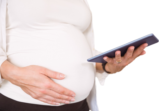 Midsection of pregnant woman using tablet computer