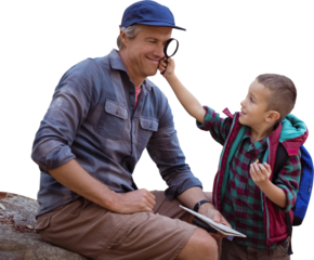 A little boy showing magnifying glass to his father 