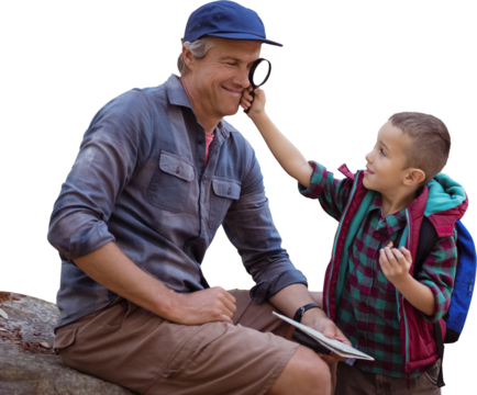 A little boy showing magnifying glass to his father 