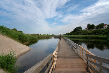 View of the promenade in the village of Yantarny along the Baltic Sea line on a sunny summer day,...