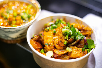 grilled potatoes in a paper bowl